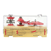 Three Freud router bits with red bases and metal shanks displayed in a wooden case with labeled compartments for coping, stic