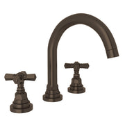 Tuscan brass three-piece widespread lavatory faucet with curved C-spout and cross handles.