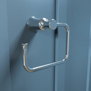 Chrome towel ring with cylindrical wall mount and open rectangular ring design on blue wall.