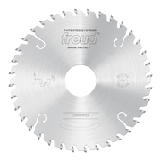 Silver circular saw blade with conical scoring teeth around the edge and central arbor hole.