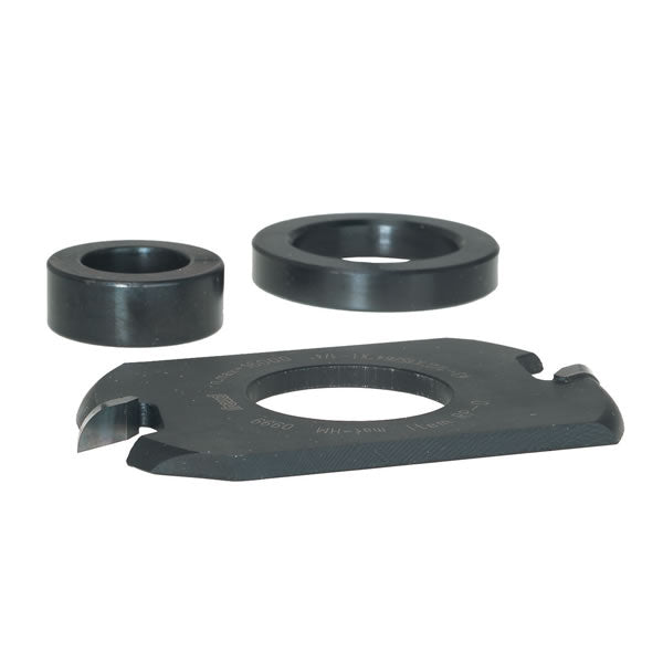 Three dark metal router bit components: two cylindrical spacers and one larger flat cutter head with central opening.