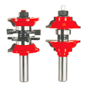 Two router bits with red cutting heads and steel shafts, one with curved edges and one with decorative profile.