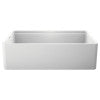 White apron front single bowl kitchen sink with stainless steel interior and rim.