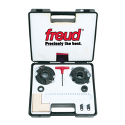 Freud RS1000 router bit set in black carrying case with two saw blades, red wrench, washers, and wooden sample block.