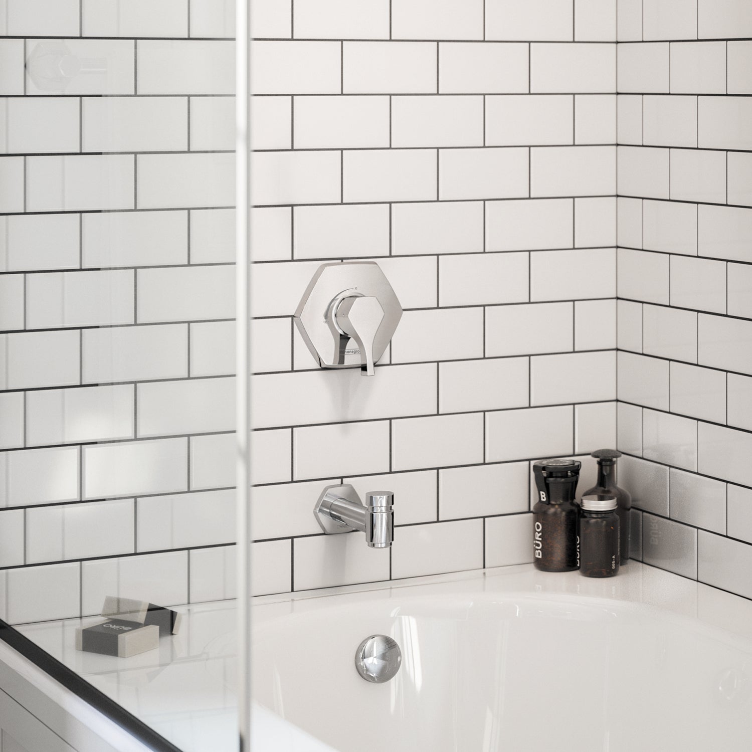 Chrome tub spout with diverter mounted on white subway tile above a bathtub.