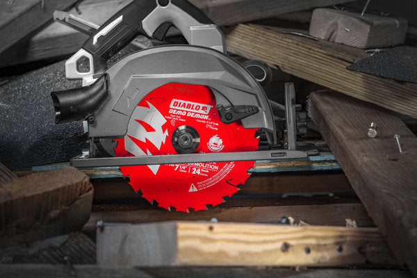 Red and gray circular saw blade with 24 teeth mounted on power saw, positioned over wooden material.