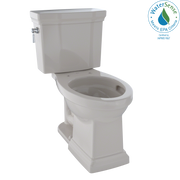 Beige two-piece elongated toilet with tank, bowl, and supply line visible from side angle.