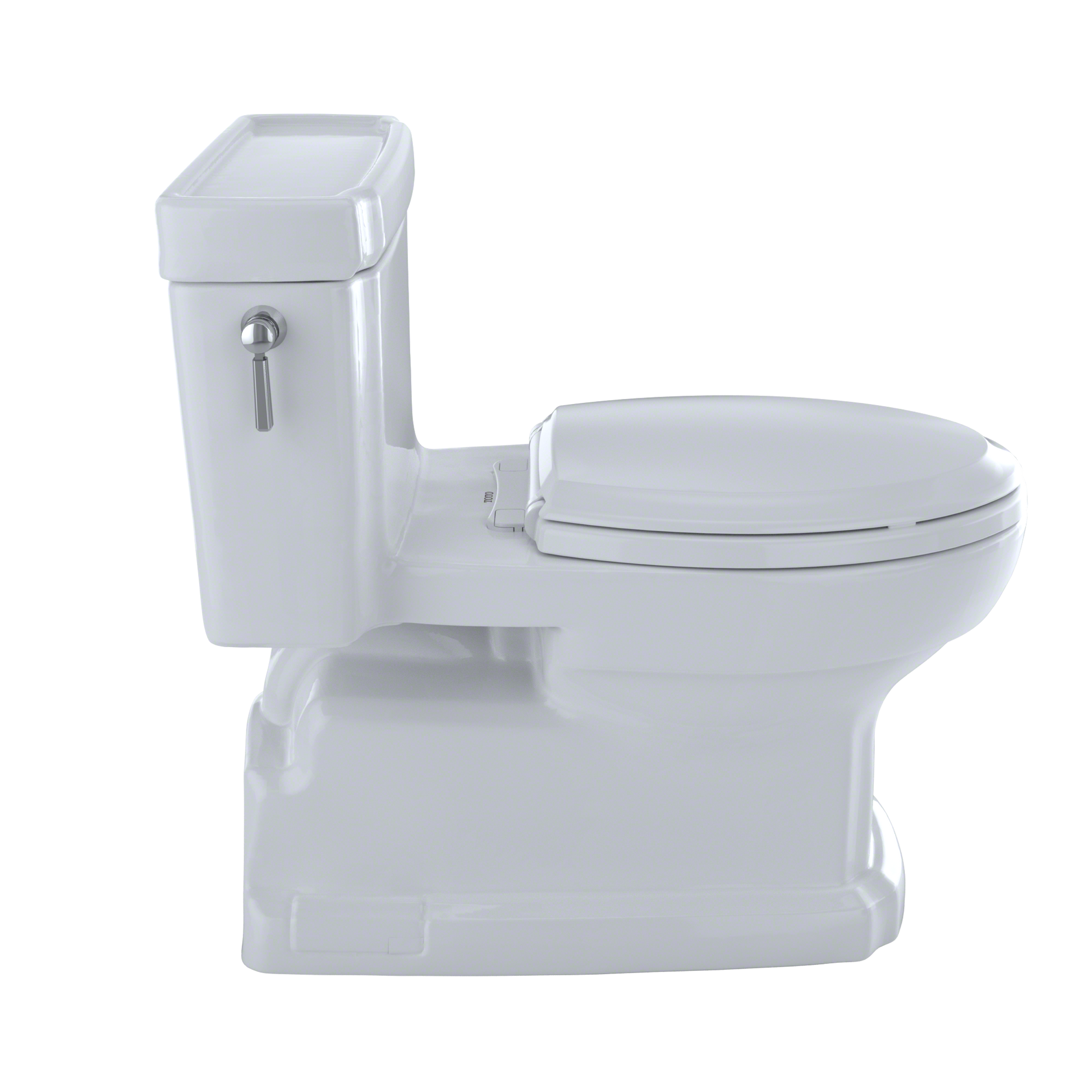 White elongated toilet with integrated tank, soft-close seat, and chrome handle lever on left side.