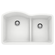 White undermount kitchen sink with two unequal basins and low divide, featuring chrome drain strainers.