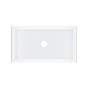 White fireclay single bowl undermount kitchen sink with faucet hole, rectangular shape with raised edges.
