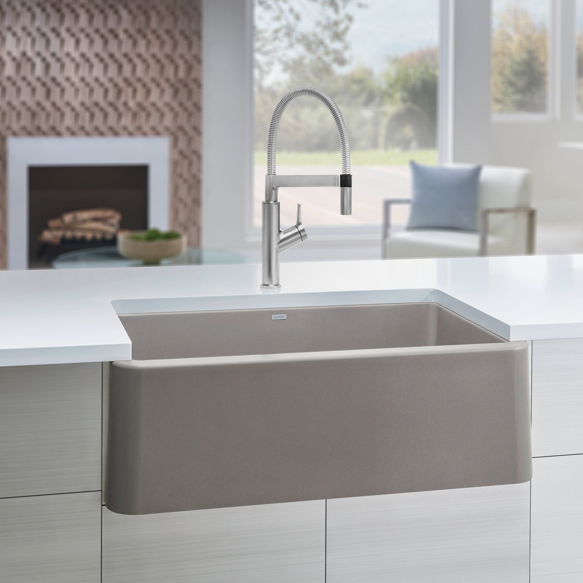 Truffle single-bowl farmhouse sink with curved front apron and brushed stainless steel pull-down faucet installed in white co