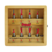 Eight Freud router bits with red handles and metal shanks arranged in wooden storage case with compartments.