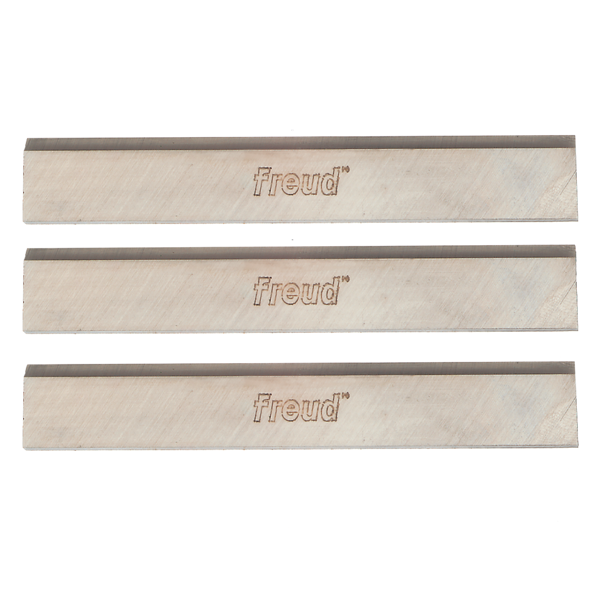 Three rectangular high speed steel planer knives with dark cutting edges and Freud branding stamped on light-colored bodies.