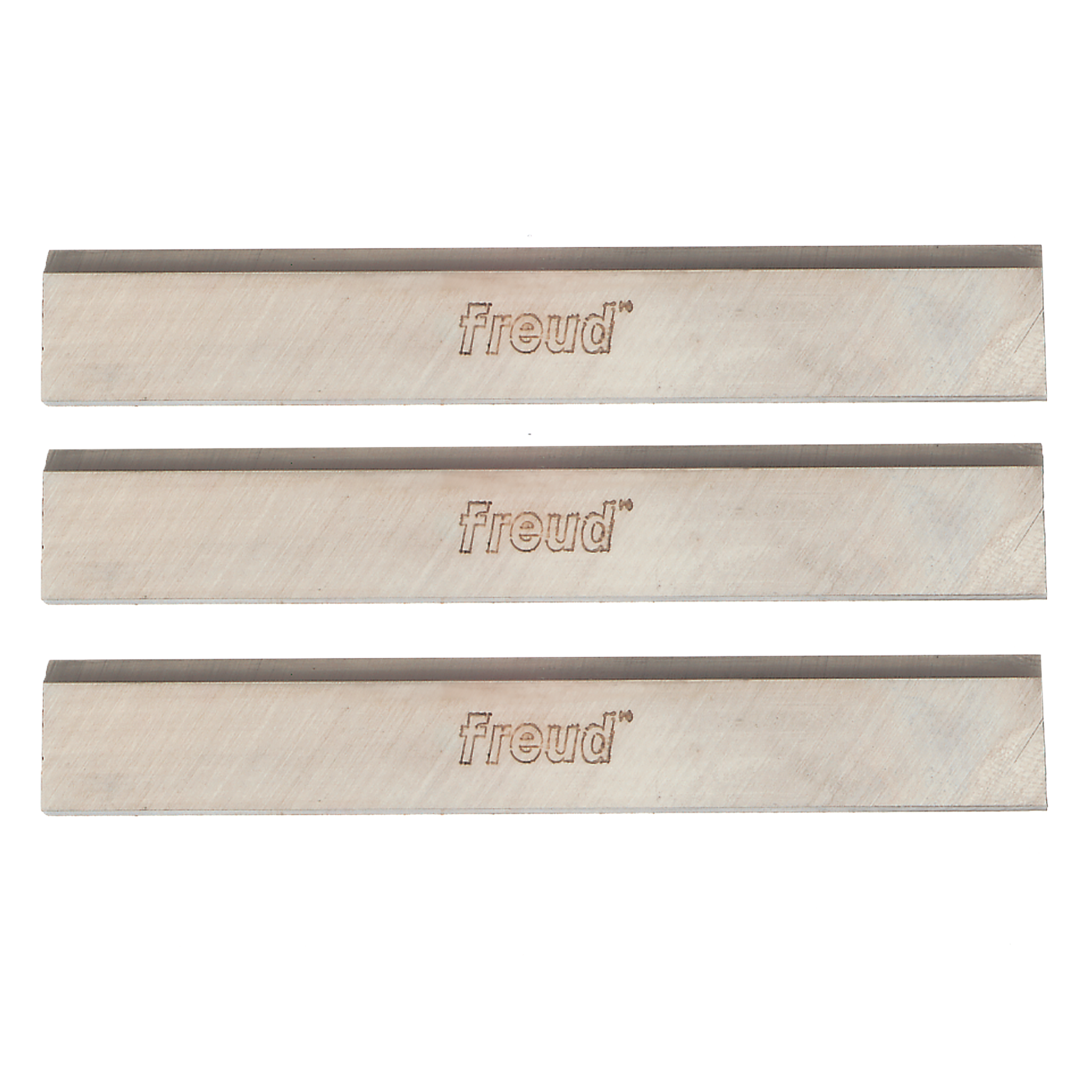 Three rectangular high speed steel planer knives with dark cutting edges and Freud branding stamped on light-colored bodies.