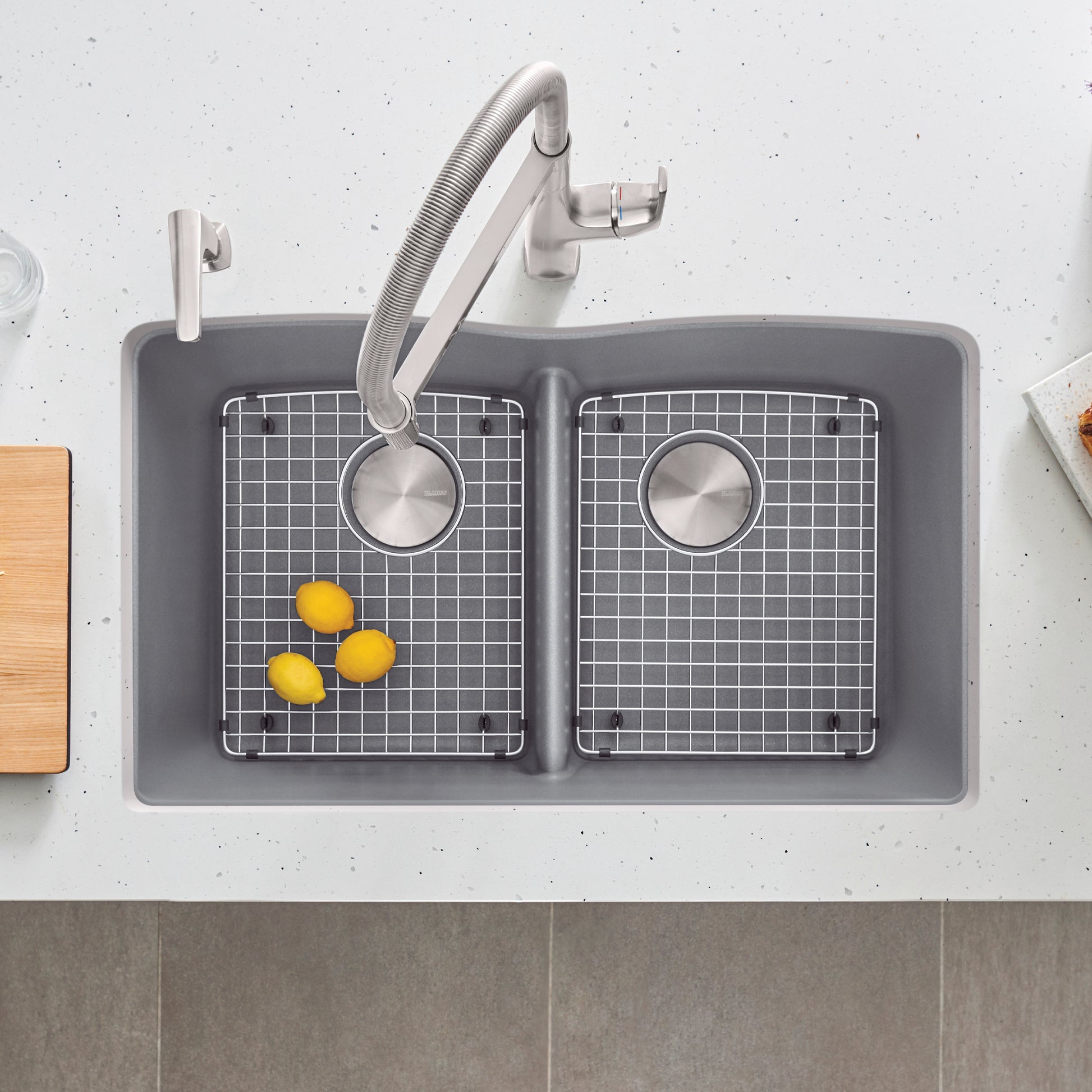 Stainless steel sink grid with fine mesh pattern fitting into double basin sink compartment.