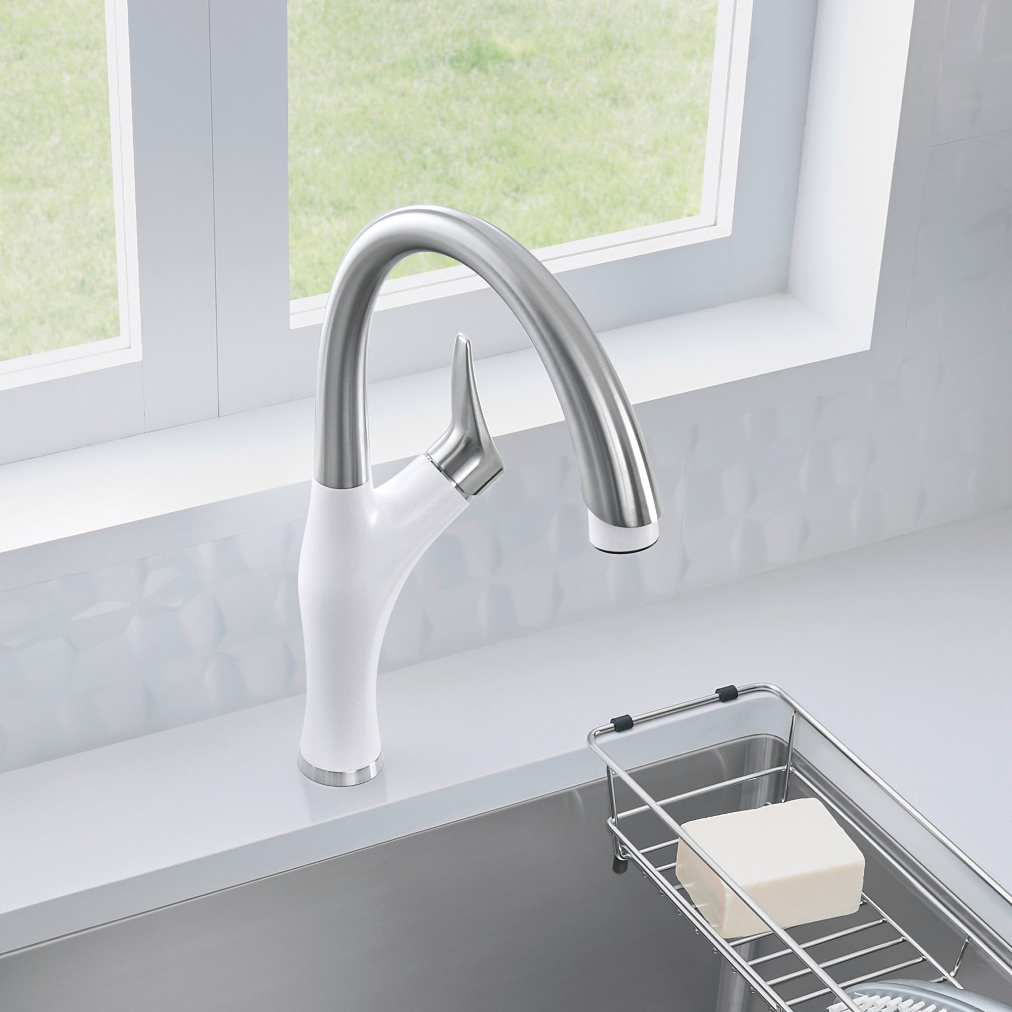 White and stainless steel pull-down kitchen faucet with curved spout mounted on sink counter.