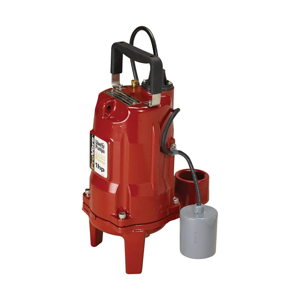 Red cast iron grinder pump with black discharge hose and gray float switch attached.