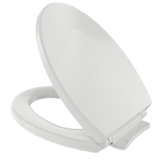 White elongated toilet seat and lid with closed lid positioned at an angle, showing the seat ring and hinge mechanism.
