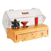 Three router bits displayed in wooden storage case with clear plastic lid and instructional diagrams.