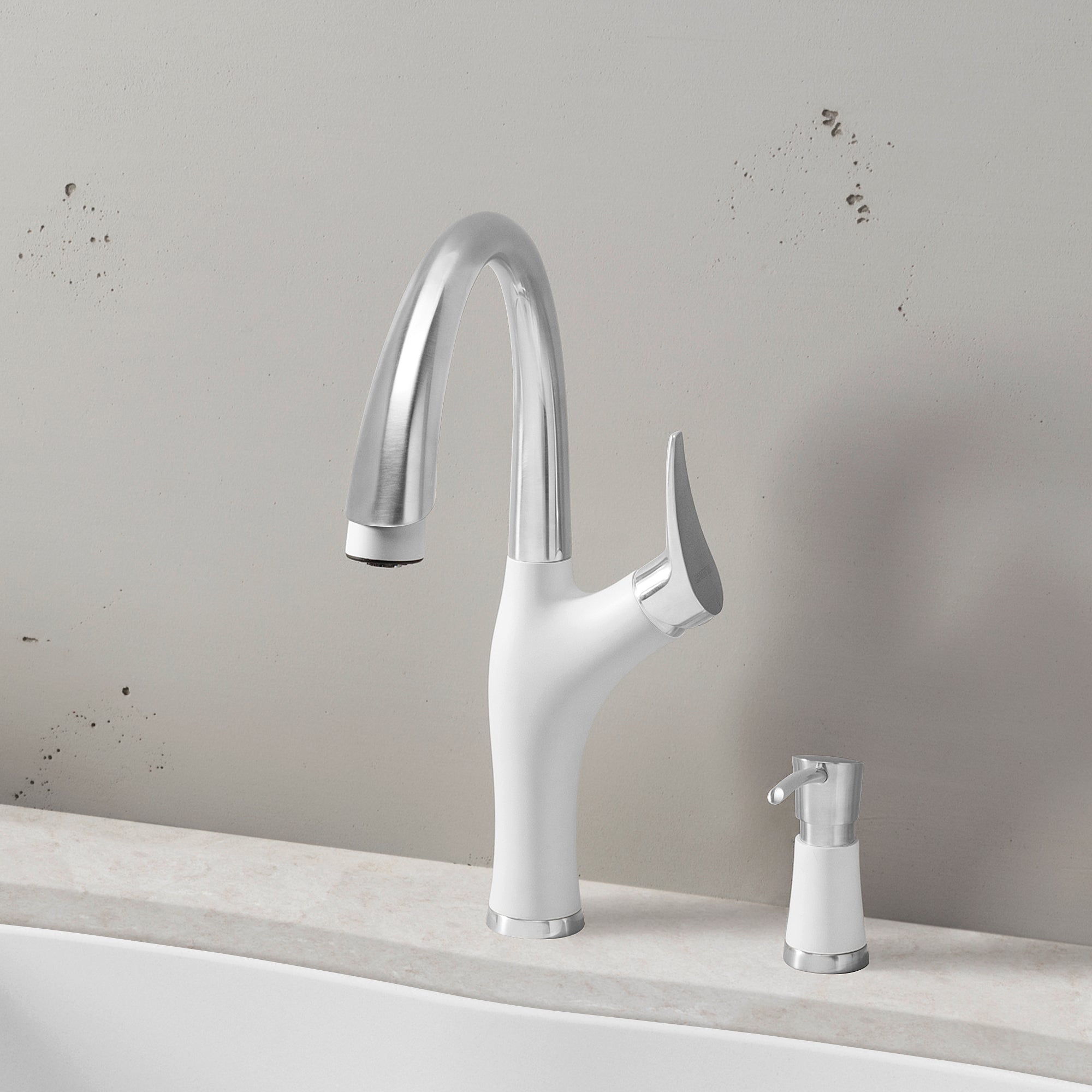 White and stainless steel pull-down kitchen faucet with curved spout and single lever handle on countertop.