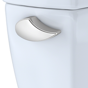 Polished nickel curved trip lever mounted on white porcelain toilet tank.