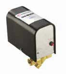 McDonnell & Miller electronic water feeder with black casing, white label, and brass connector fittings.