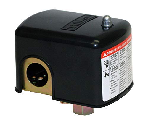 Black rectangular pressure switch with brass port opening, adjustment screw on top, and red warning label on side.