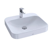 White rectangular vessel sink with chrome single-hole faucet and drain cover.