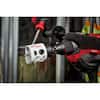 Milwaukee 3-1/4" bi-metal hole saw with arbor attached to drill chuck.