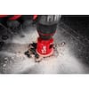 3/4-inch diamond hole saw with red metal construction and dust spray effect on gray surface.