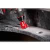 Diamond hole saw with red shank cutting through concrete surface.