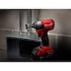 Red and black Milwaukee Shockwave impact hole saw kit with carrying case on dark surface.