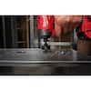 Milwaukee Shockwave 7/8 inch impact hole saw bit with red and black packaging on dark surface.