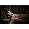 Milwaukee ergonomic locking plier with 10-inch jaws held in hands against dark background.