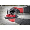Milwaukee FASTBACK red and black folding utility knife with blade storage compartment, shown in hand.