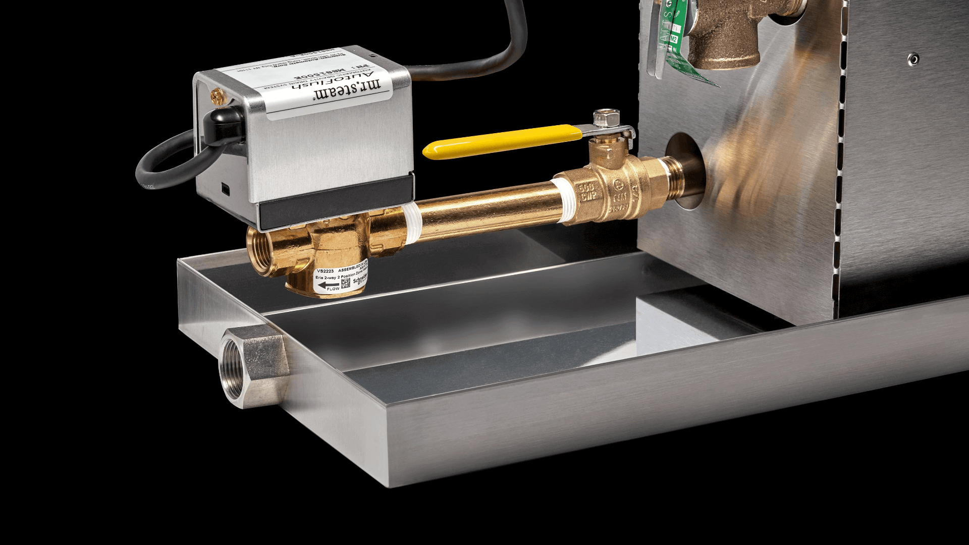 White and brass AutoFlush system with control unit, brass valve assembly, and yellow lever mounted on metal drip pan.