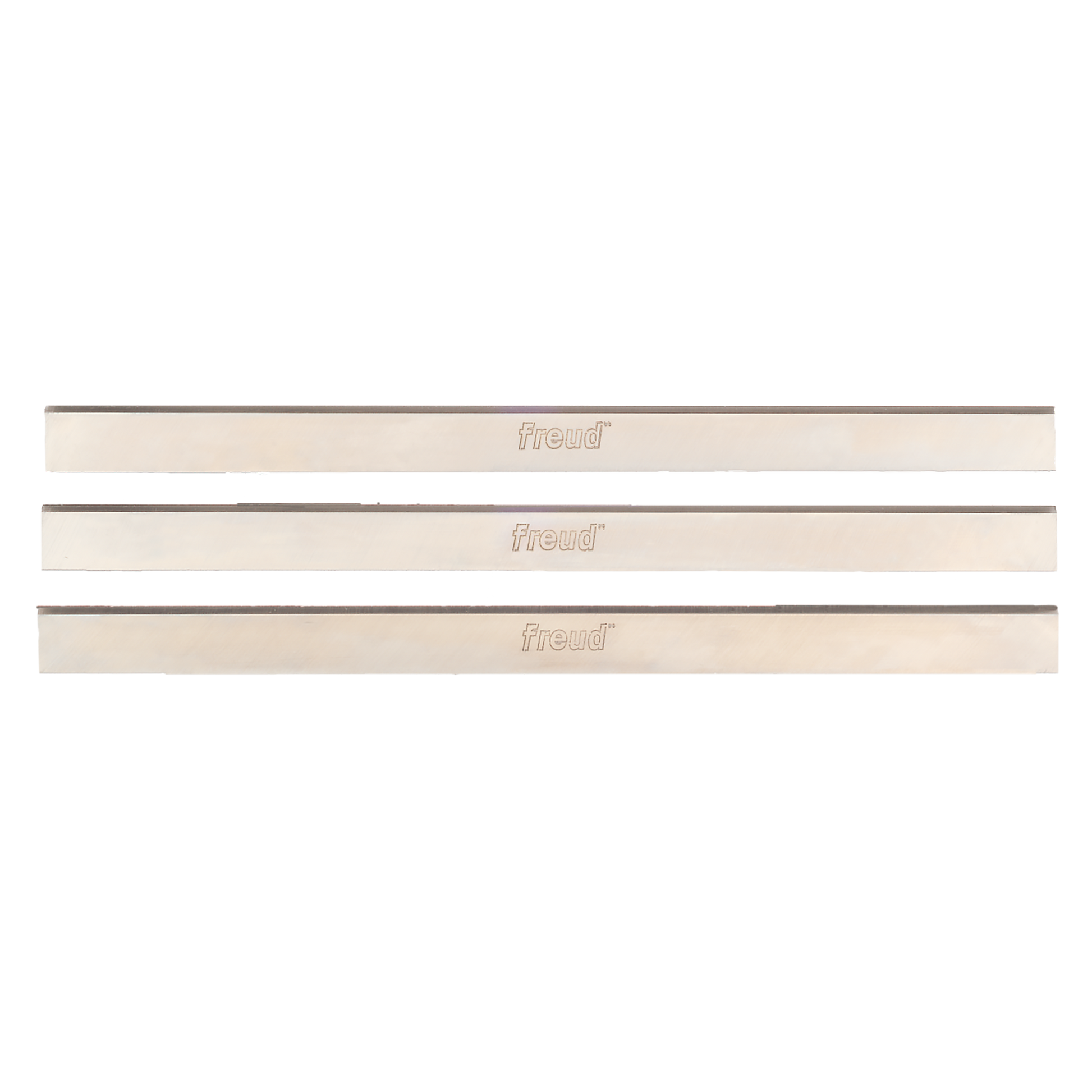 Three Freud high speed steel planer and jointer knives with cream-colored backing and dark cutting edges.