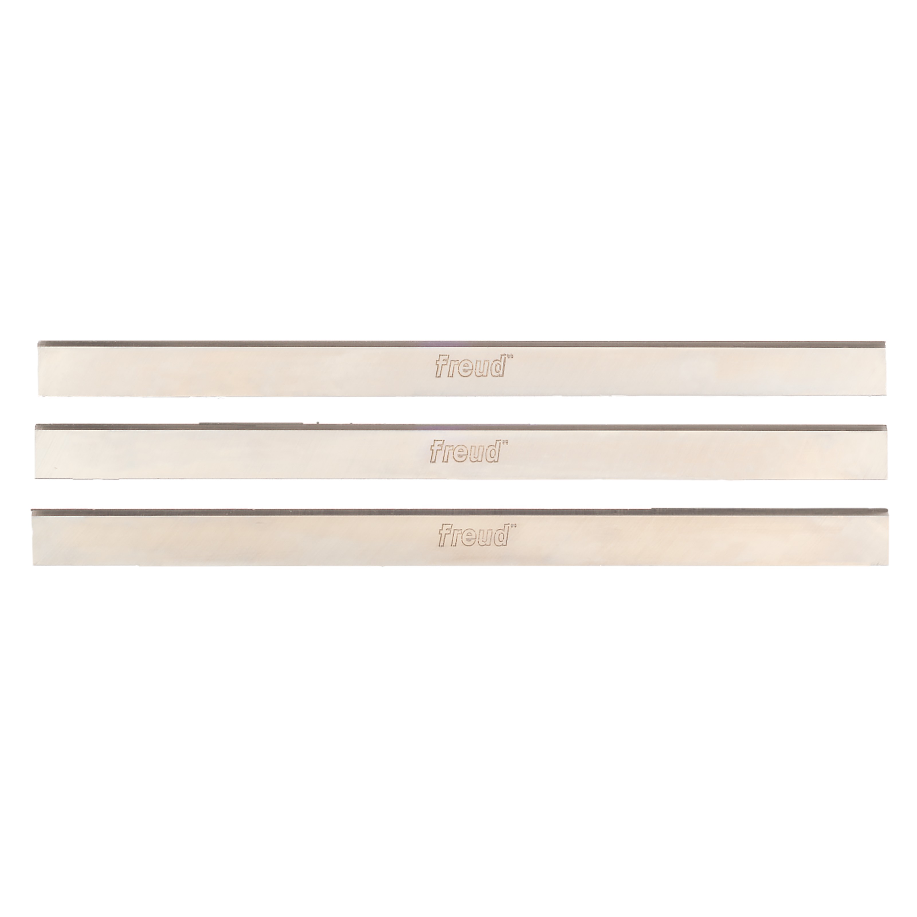 Three Freud high speed steel planer and jointer knives with cream-colored backing and dark cutting edges.