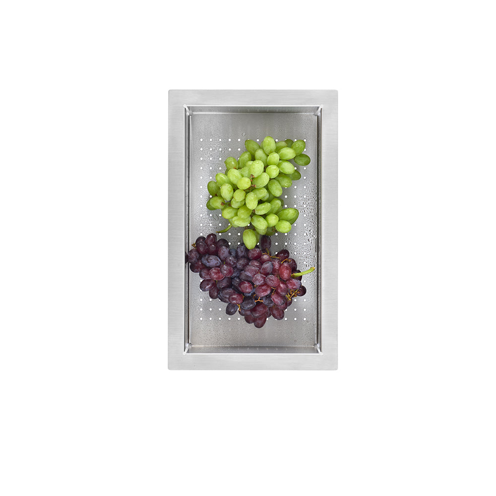 Stainless steel rectangular colander with perforated surface holding green and red grapes.