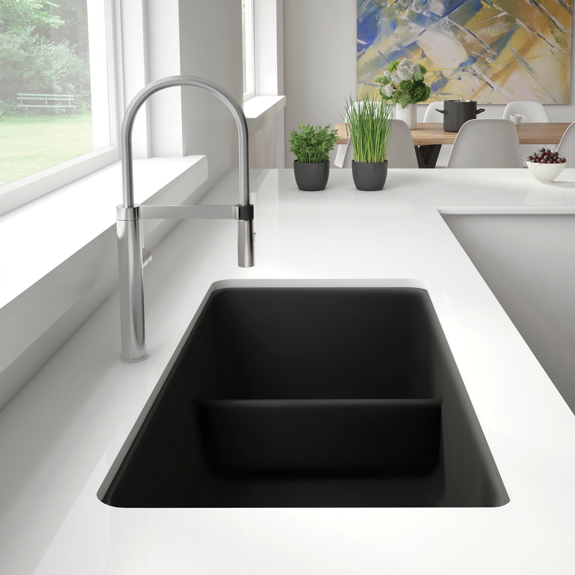 Anthracite undermount kitchen sink with low divide and pull-down faucet in modern kitchen setting.