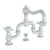 Polished nickel bridge-style lavatory faucet with curved spout and two lever handles.