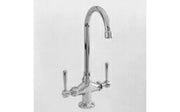 Chrome bar faucet with curved spout and two lever handles mounted on single base.