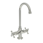 Polished nickel prep/bar faucet with curved spout and dual cross handles on round base.