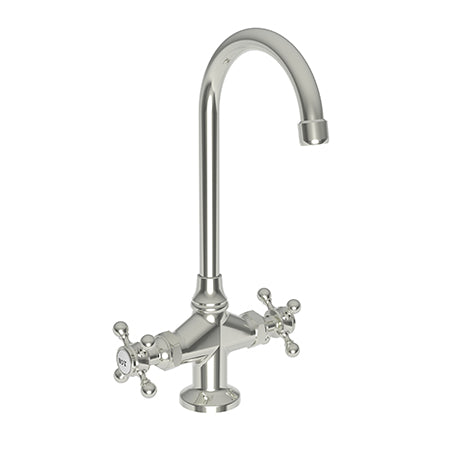 Polished nickel prep/bar faucet with curved spout and dual cross handles on round base.