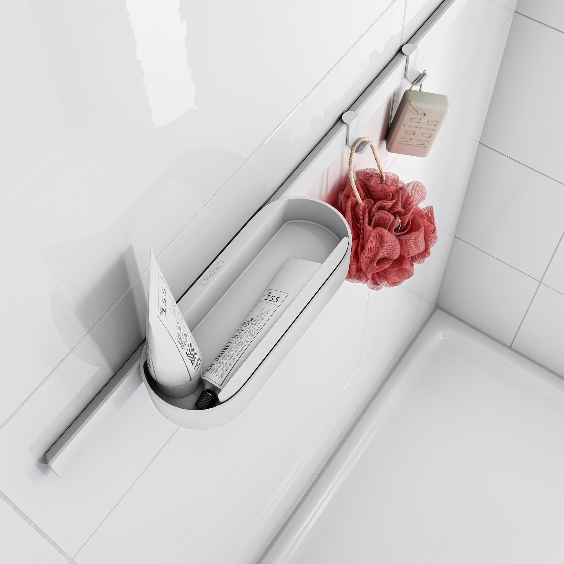 Matte white slim towel hook mounted on bathroom wall with red loofah and soap hanging from it.