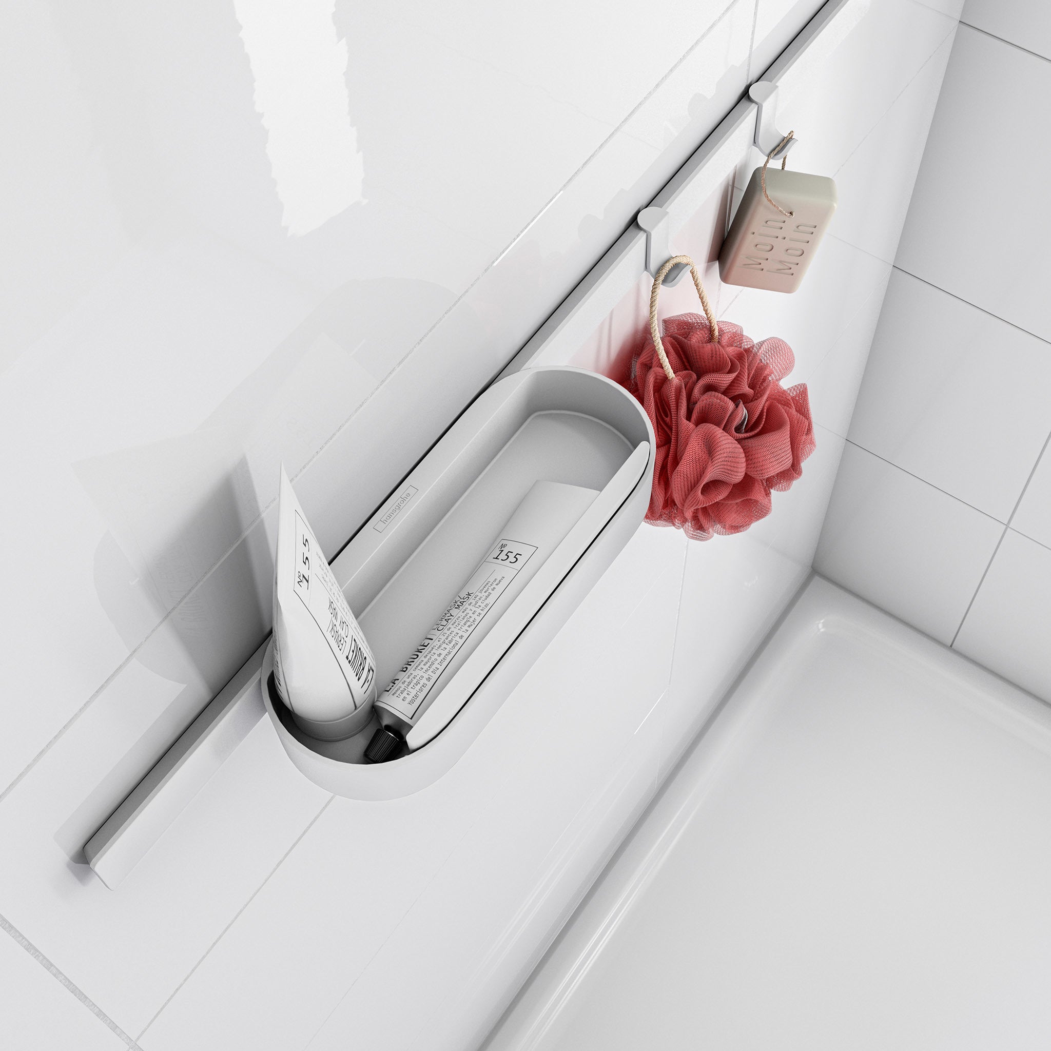 Matte white slim towel hook mounted on bathroom wall with red loofah and soap hanging from it.