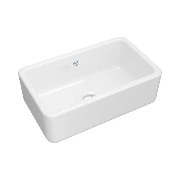 White fireclay farmhouse apron front kitchen sink with single bowl and rounded corners.