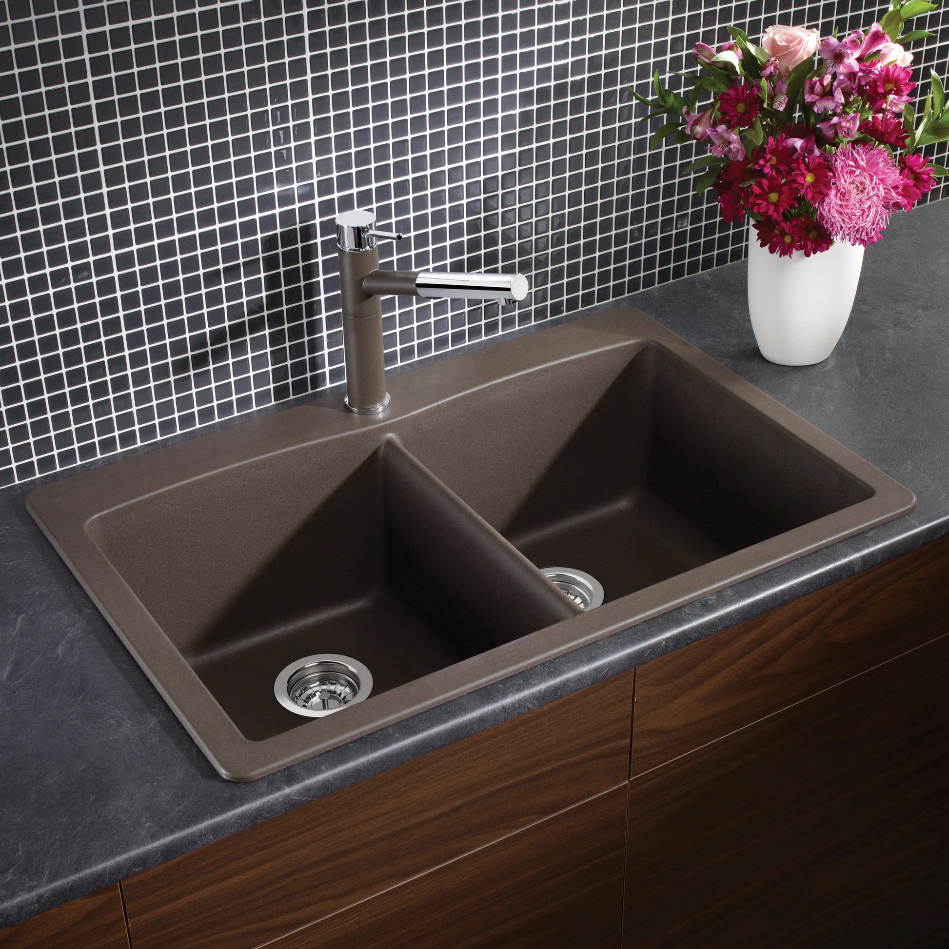 Cafe brown double bowl drop-in kitchen sink with chrome faucet installed in dark countertop.