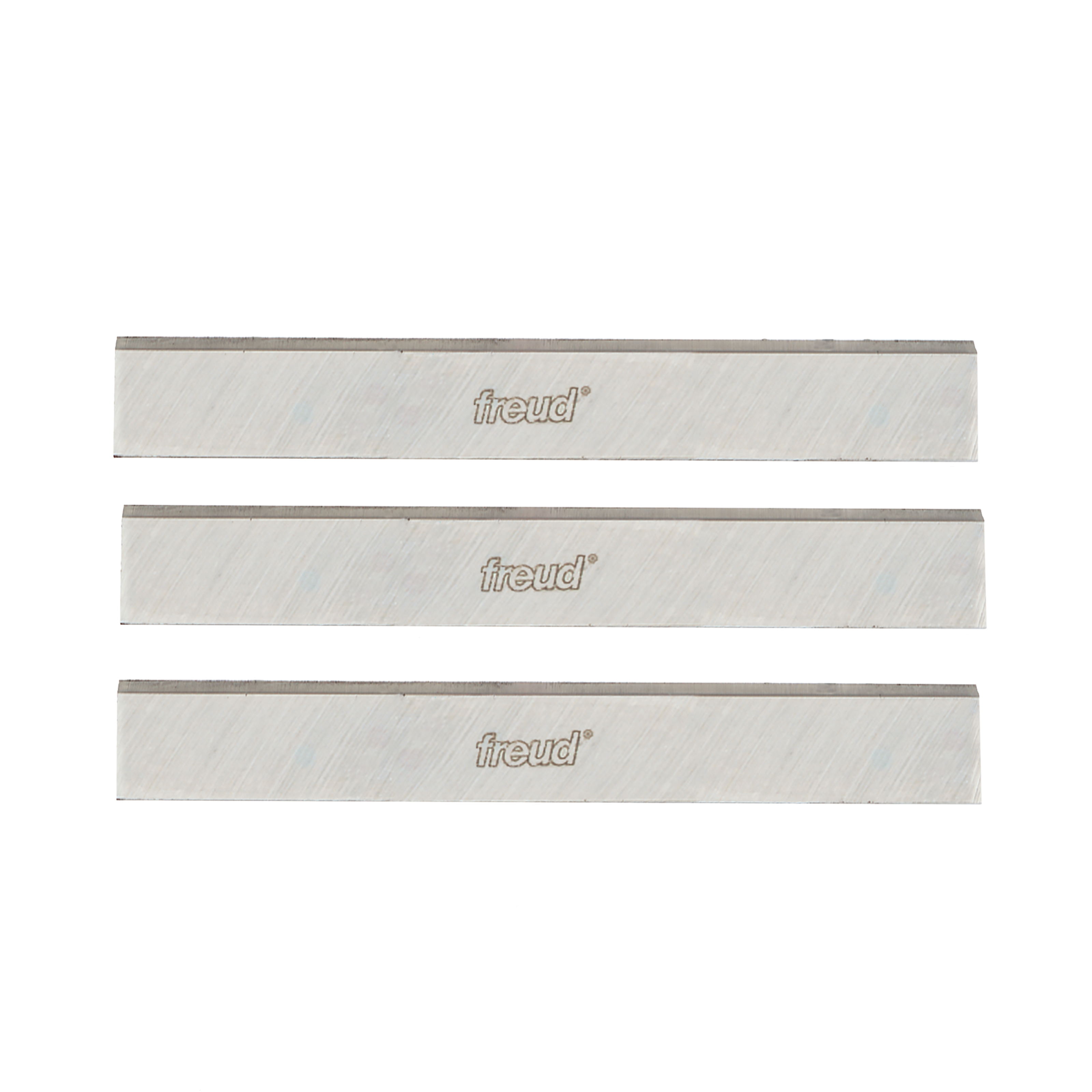 Three metallic planer and jointer knives with Freud branding and diagonal texture pattern on light-colored cutting surfaces.