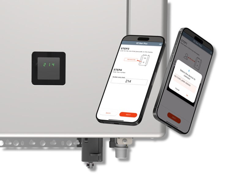 Black wall-mounted digital control panel displaying temperature and two smartphones showing installation setup steps for tank
